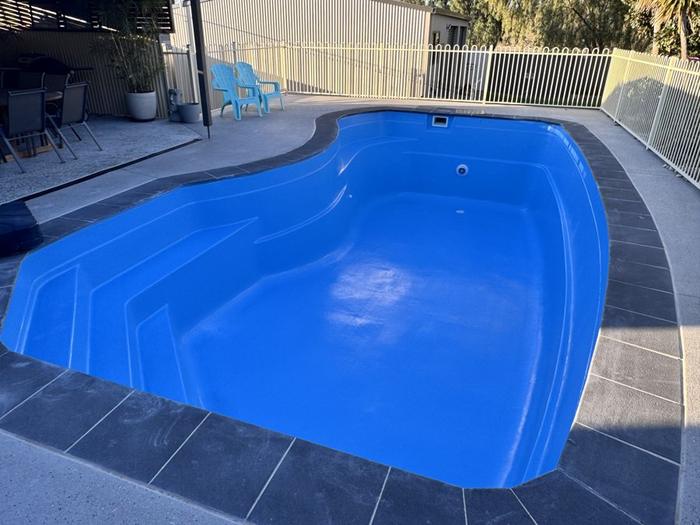 Pool with steps and swim-out in bright blue