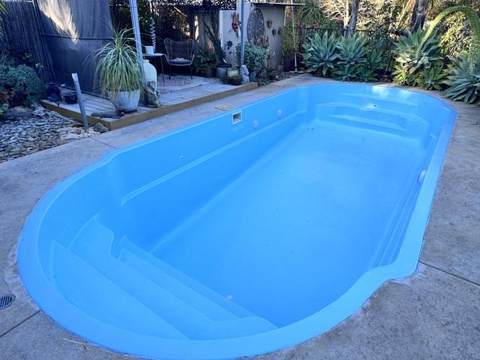 Freeform pool with steps in light blue, before filling