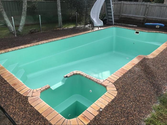 Pool and attached spa in aqua, before filling